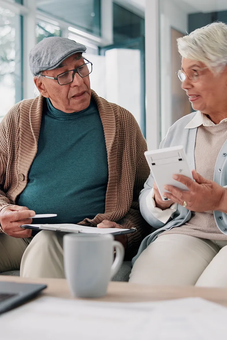 A retired couple reviewing paperwork together at home