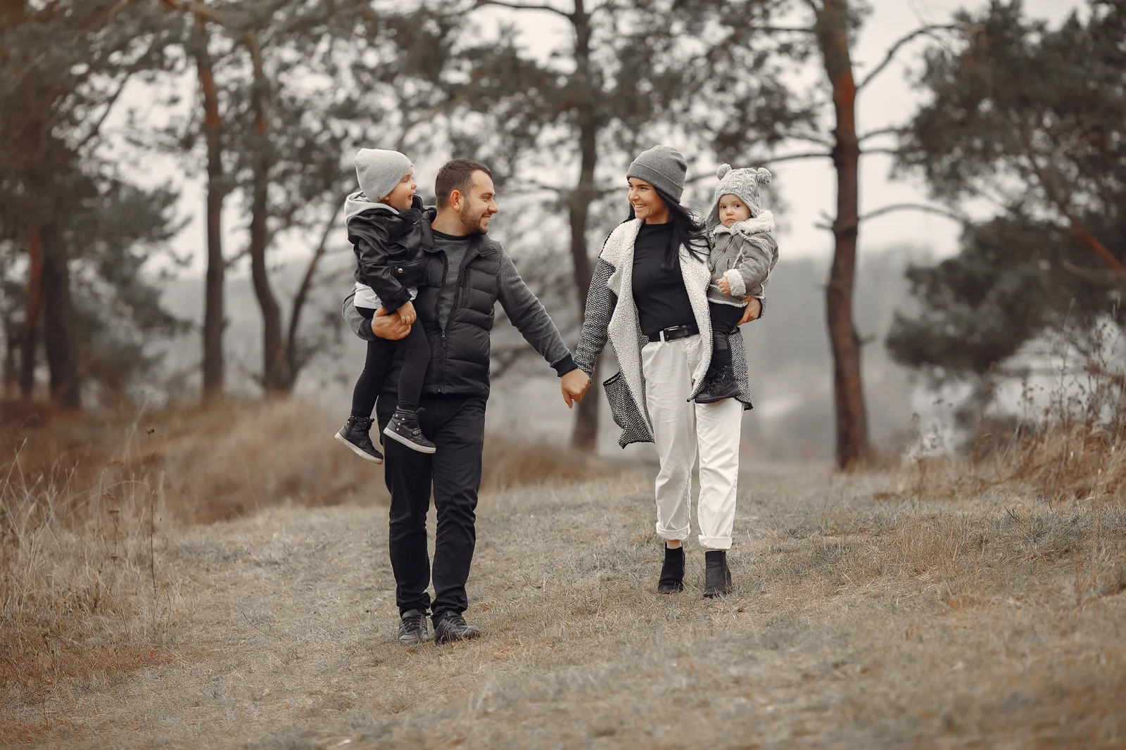 A family walking outdoors together on a winter day